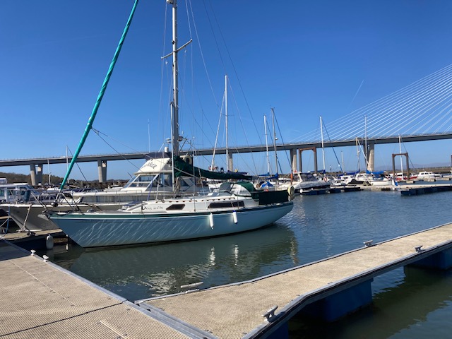 The New Forth Road Bridge in the background. A Sailing boat, the Green Dolphin II in the foreground of a marina